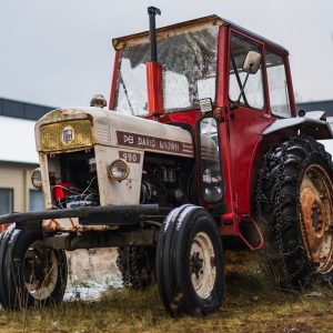 A tractor parked in a field next to a building