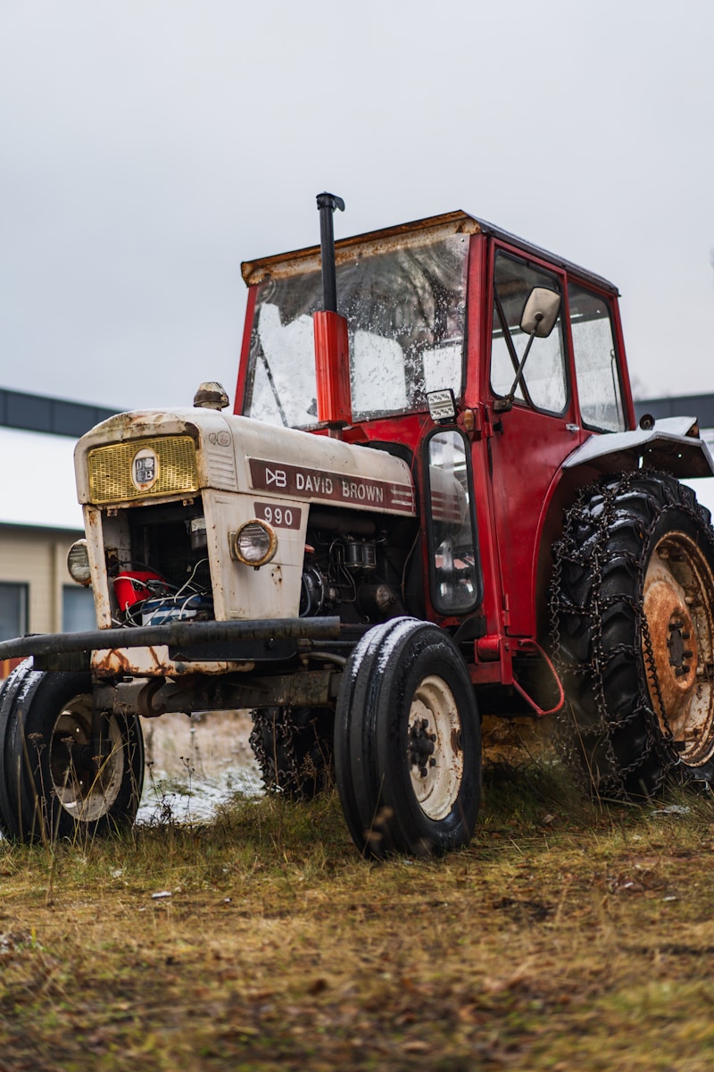 A tractor parked in a field next to a building